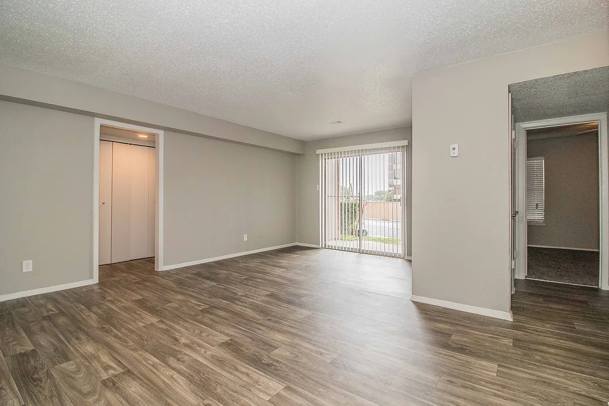 Enjoy open living spaces with modern flooring and natural light throughout your home. - Verano Oaks Apartments