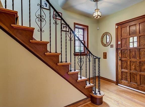 Solid wood door at the entry with a coat closet.