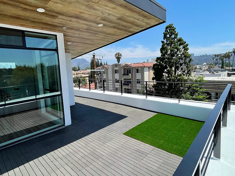 Private rooftop patio with decking and pet friendly synthetic turf. Shaded cantilever with dimmable led lighting. Sunset views.