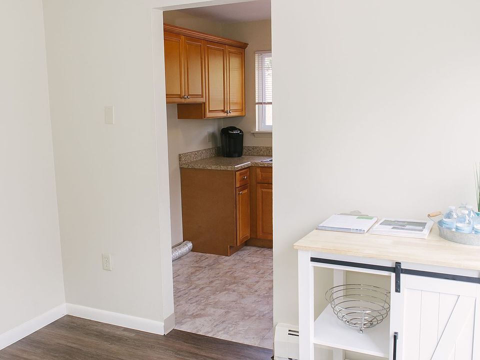 Dining Room With A Farmhouse Style Drink Cart Looking Into Modern, Updated Kitchen.