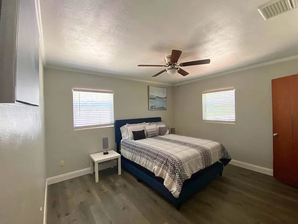 Bright, spacious queen bedroom with ceiling fan and beautiful decorative wall art. Lakeland, FL