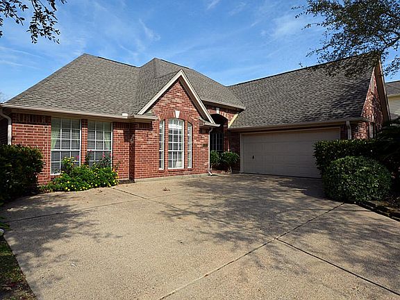 A closer look at the front of the house with beautiful brick on all sides and great landscaping acce