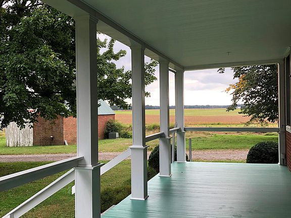 Front porch, carriage house/ garage/ storage area.