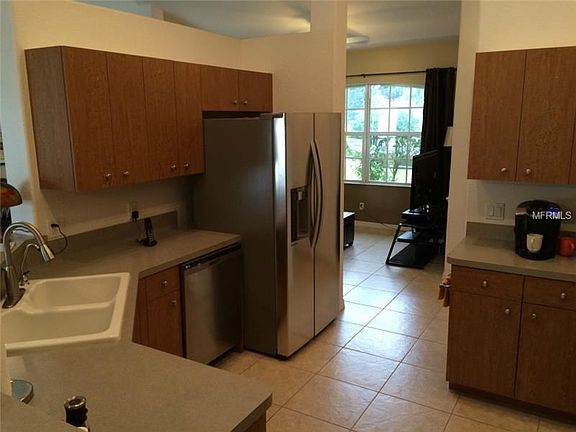 Well designed kitchen with stainless newer refrigerator.