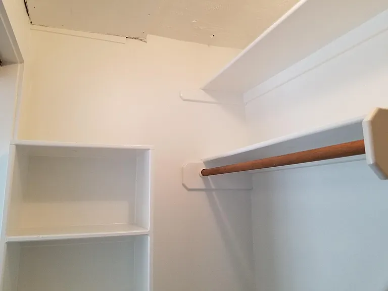 Bedroom closet with rods to hang clothes and built in shelves for your shoes, pants or sweaters.