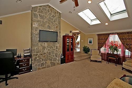 Living room with cathedral ceiling, remote control skylights