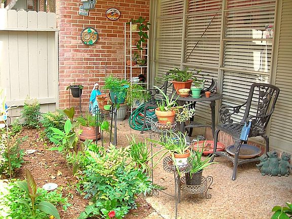 Just inside the gate is a small covered patio & garden area.  Great place to plant a flower garden.