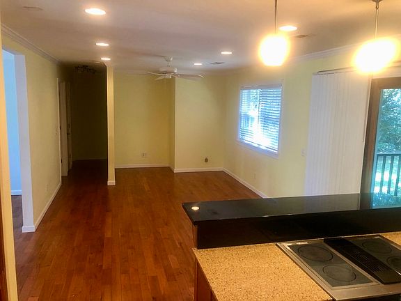 The tv room from the kitchen. The living room and dining room (not pictured) are on either side as you as you walk in front door (through the walkway on the left of this picture). The screened in porch is off the right of this picture.