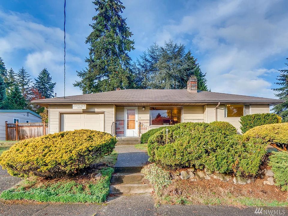 Well maintained exterior, one garage at road level and one at lower level to left of home