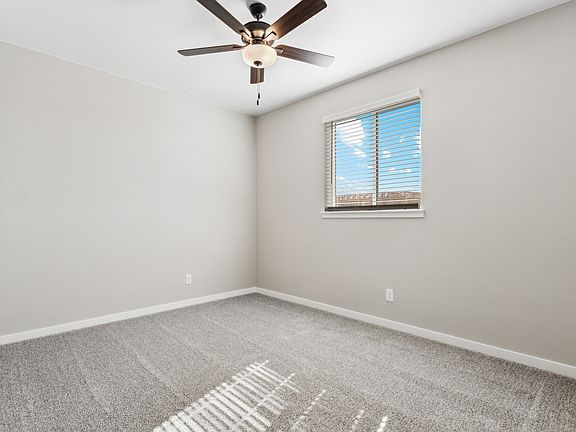 The master bedroom is spacious with a large window.