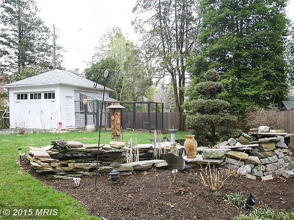 Rear yard with fish pond, roomy Garage and aviary.