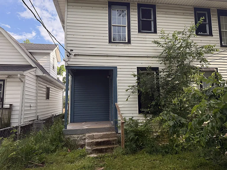 kitchen opens to fenced in backyard with 2 spots for car parking in the back