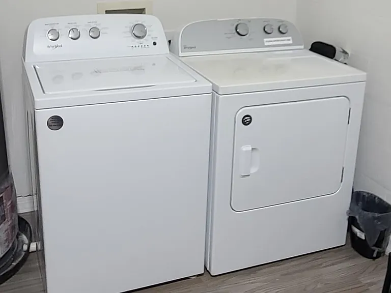 Dedicated laundry area with a full-size washer and dryer for convenient in-home laundry days.