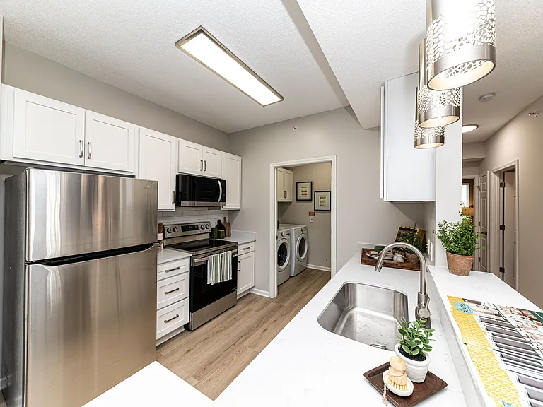 Kitchen with quartz counters, modern cabinetry, & stainless appliances