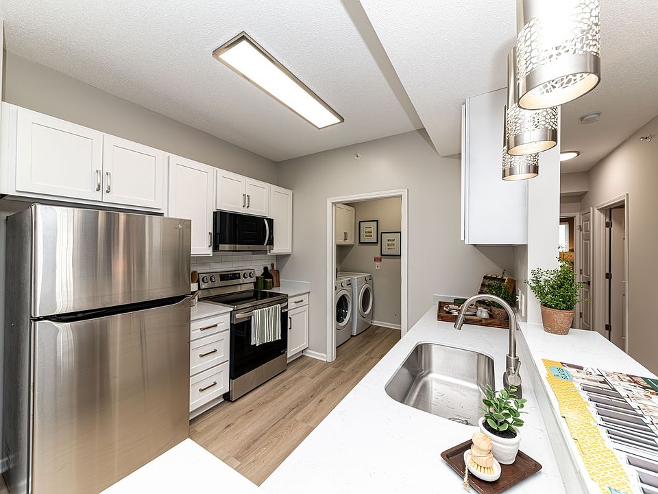 Kitchen with quartz counters, modern cabinetry, & stainless appliances