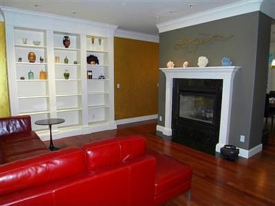 Living room with double sided fireplace & classic built-ins.