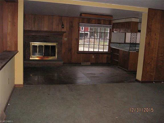 Dining area off kitchen with fireplace. This would make a lovely formal dining area or sitting area.