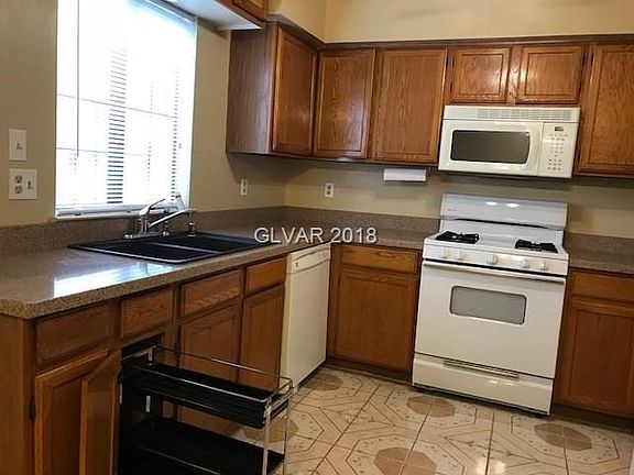 A pullout drawer is a nice addition in this sun-filled  kitchen.