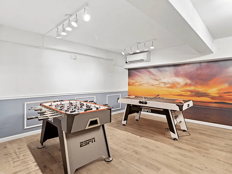 Unwind in this sleek game room designed for entertainment and relaxation.