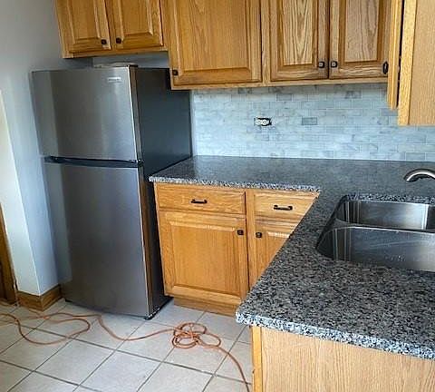 Kitchen with new appliances, granite countertops and marble backsplash