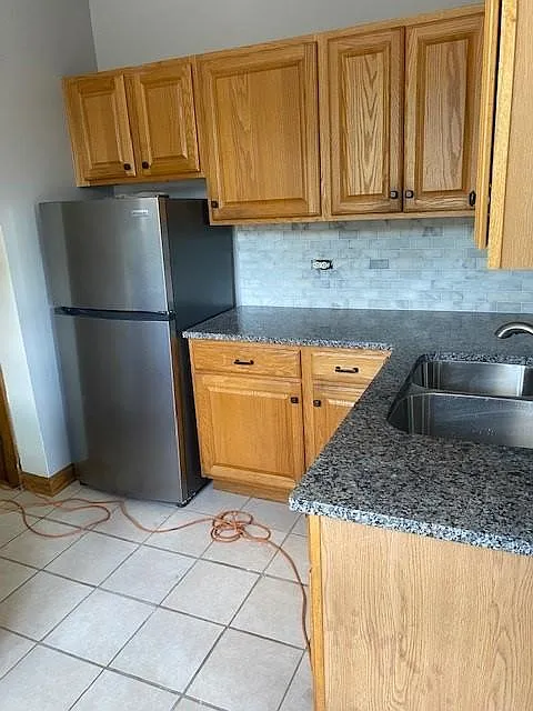 Kitchen with new appliances, granite countertops and marble backsplash
