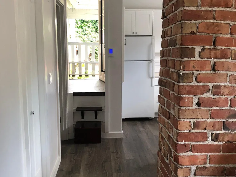 walkway to kitchen, then up two steps to back room and back exit door.