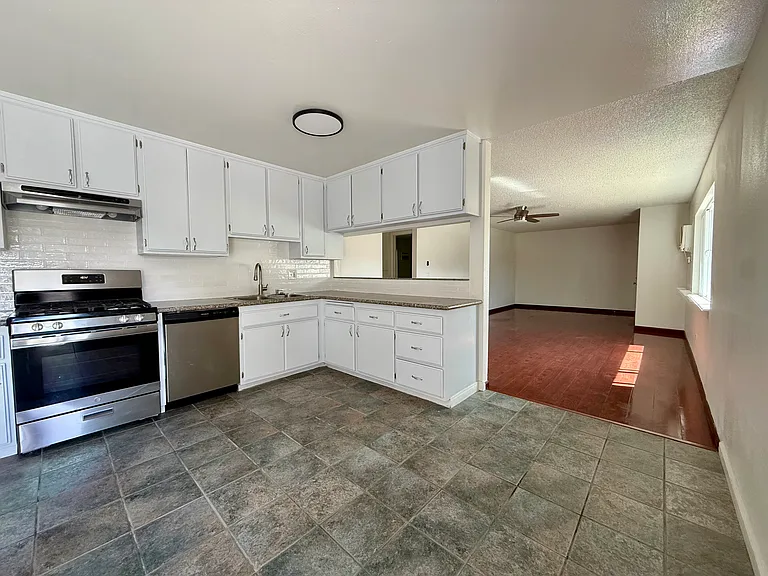 Spacious kitchen with nook area and balcony view