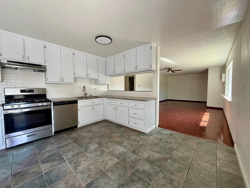 Spacious kitchen with nook area and balcony view
