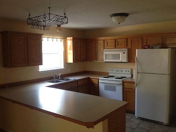 kitchen view from open dining area. Window looks into private courtyard.