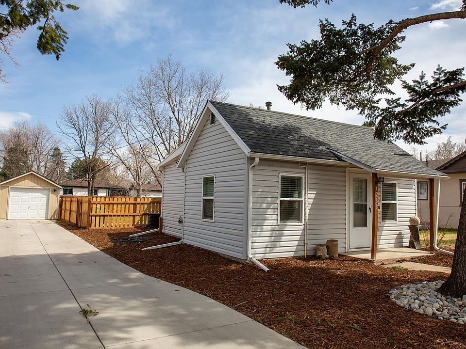 Front entrance, with large driveway and garage.