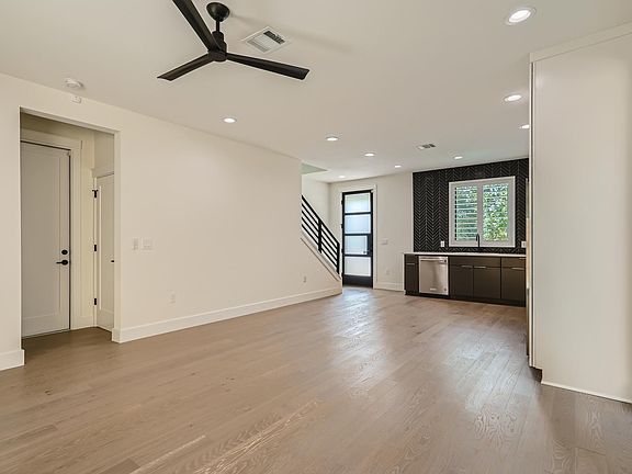 Garage access, stackable washer and dryer, and half bathroom are located off the living room.