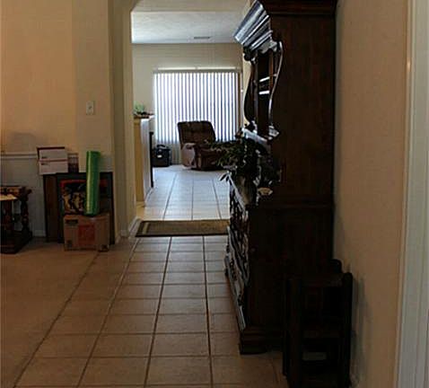 Ceramic tile in entry of home. Formal dining and living to the left.