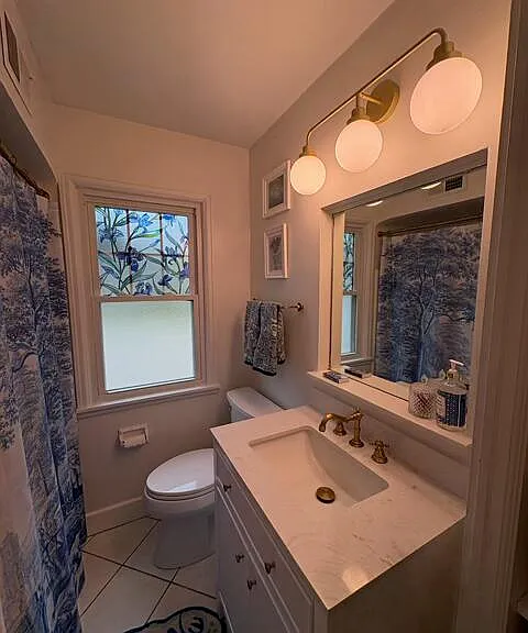 Bathroom - storage under sink and in built-in shelves next to vanity