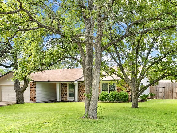 The front yard is ready for picnics and equipped with a sprinkler system.
