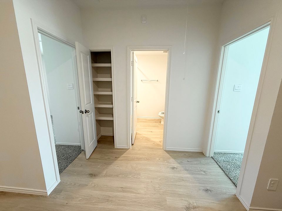 Guest bedroom 1 (right door), full bathroom (center), closet, guest bedroom 2 (left door)