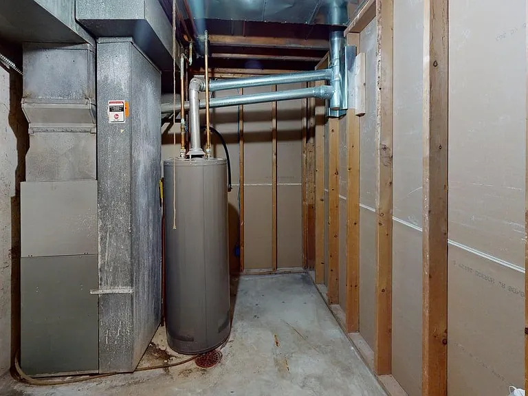 Unfinished basement area with laundry hookups