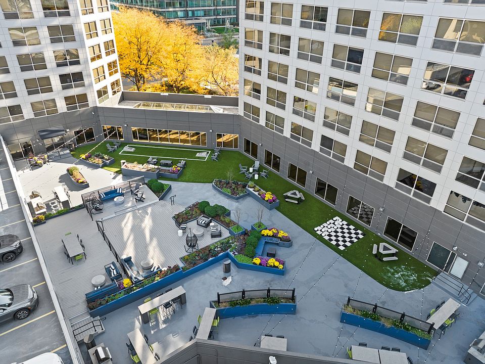 Rooftop lounge with grills, seating, and games at Presidential Towers in Chicago, IL