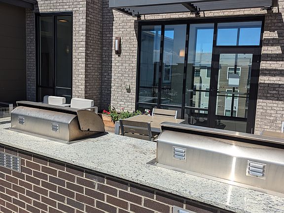 rooftop deck with BBQ grill ,seating, and fire pit