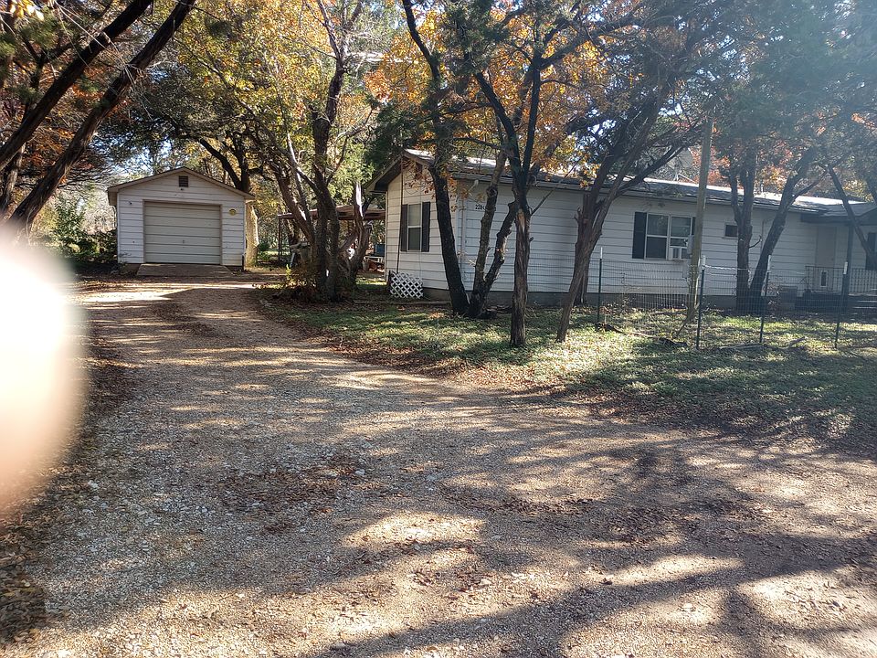 the driveway goes around the house and under the carport and continues on to the other side of the house. A circle driveway.