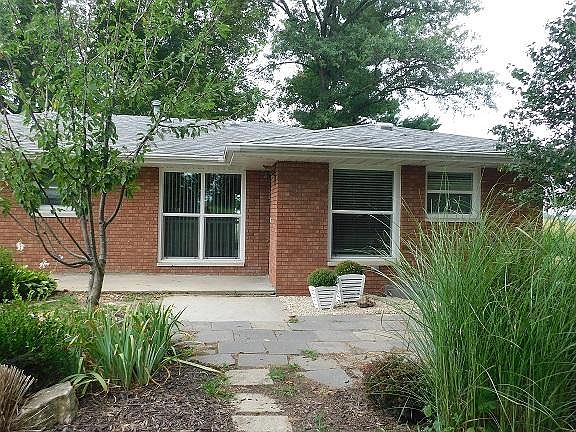 Back end entrance to house facing east showing large windows