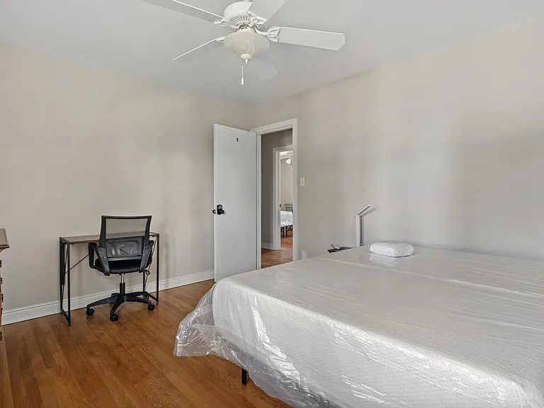 Bed room 1 - with shared bath. large window; includes a dresser, study desk, bed and bedside table.