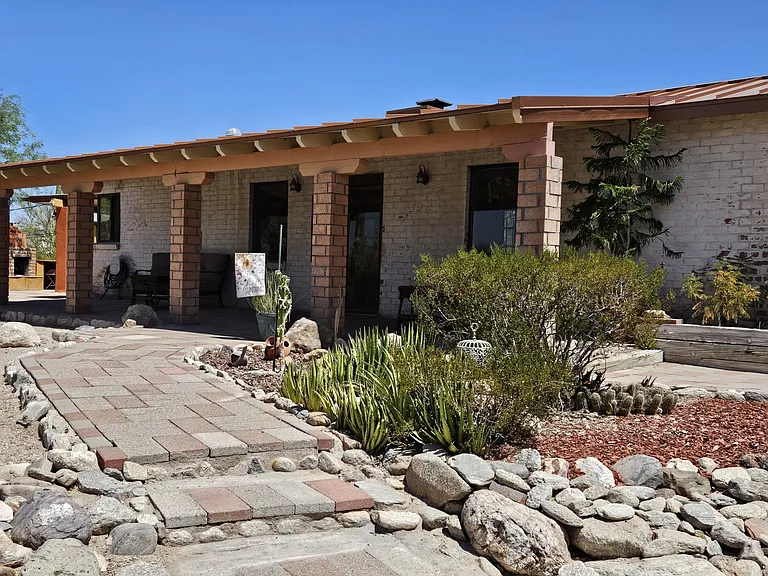 Vintage whitewashed adobe brick ranch with copper roof. Experience the feel of the "Old Pueblo". On 1.5 acres on a private road, but convenient to all Tucson has to offer.