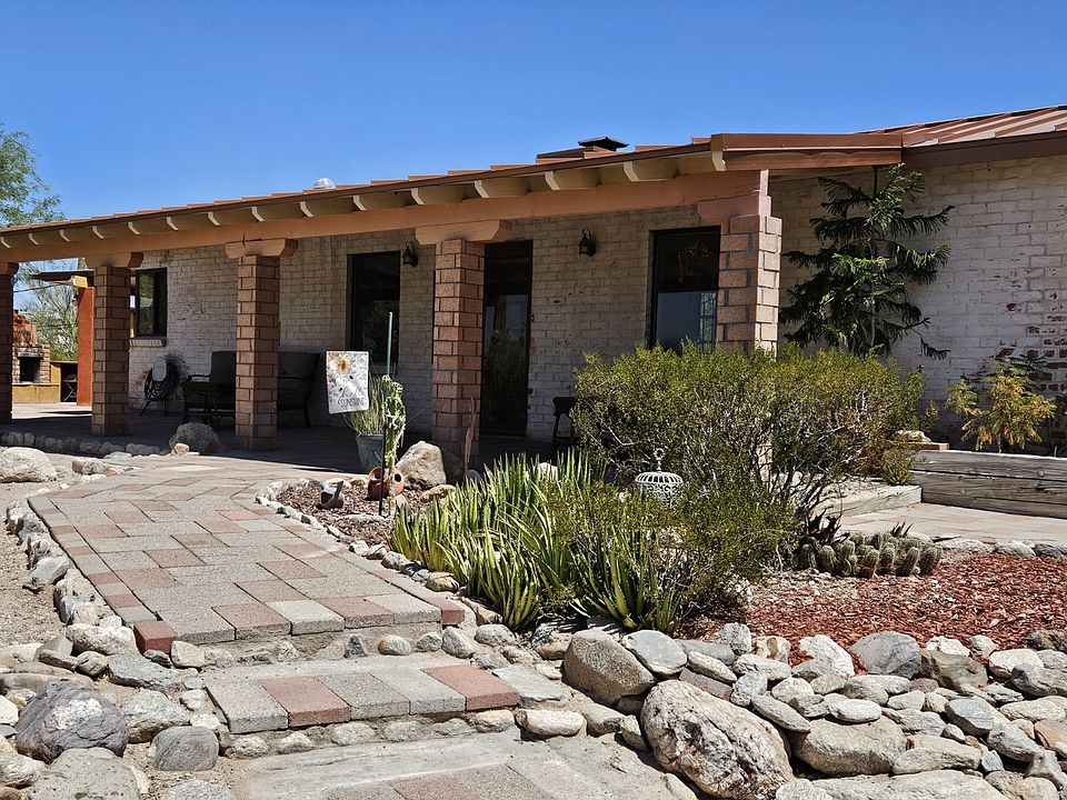 Vintage whitewashed adobe brick ranch with copper roof. Experience the feel of the "Old Pueblo". On 1.5 acres on a private road, but convenient to all Tucson has to offer.