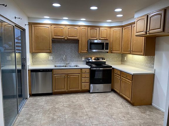 tile kitchen with lighted solid countertops brand new stainless appliances
