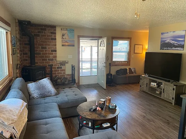 Photo 1 of 5 - 2288 Blitzen Rd #2 - South Lake Tahoe, CA open living room with woodstove - 2288 Blitzen Rd #2