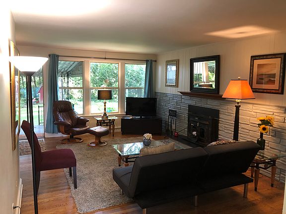 Front entrance view: bright living room, with view to covered porch and fenced back yard!