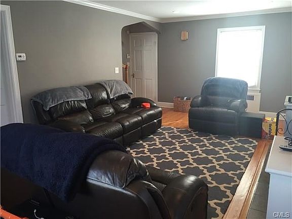 Living room facing front entrance, with archway