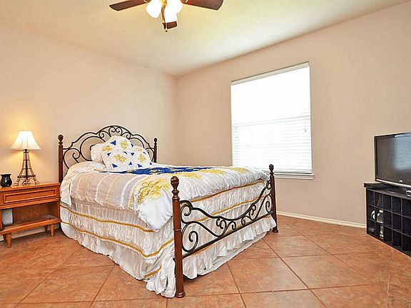 This first bedroom has the same lovely large tile used in the entry and a great window with a view o