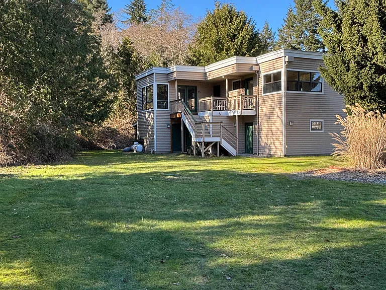 Outside of Carriage House. Surrounded by woods with water views to the East.