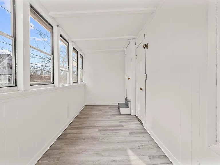Sunroom and access to second-level that has two additional bedrooms/ flex spaces.